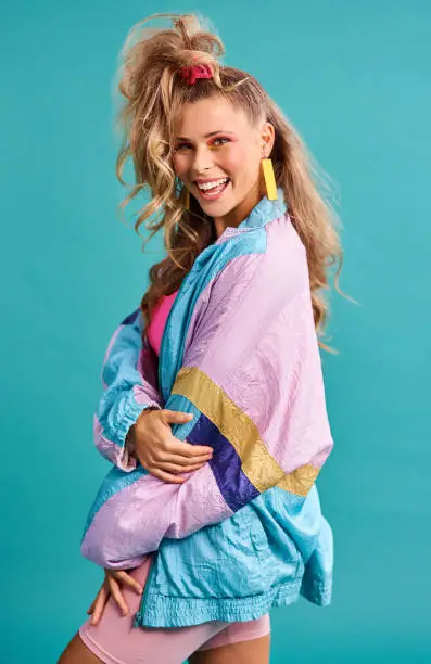 Studio shot of a beautiful young woman wearing a 80s outfit