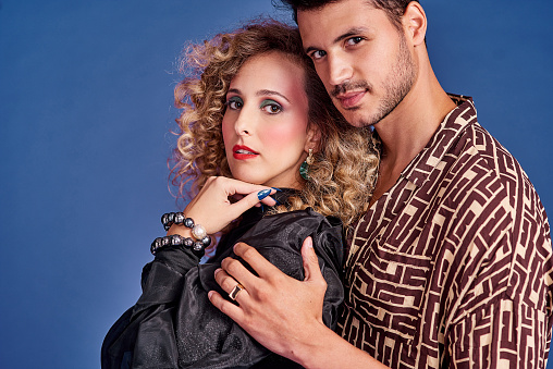 Studio shot of a young couple styled in 80s clothing
