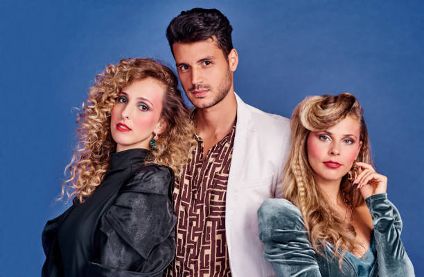 We're going back in time Shot of three young people posing together in 80s clothing against a blue background 1980s style stock pictures, royalty-free photos & images