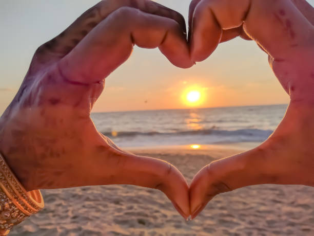 istock Beautiful sun through heart made with hands 1270445221