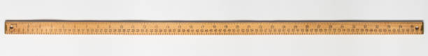 metro di misura in legno su sfondi bianchi con scale di centimetri e pollici. - tape measure ruler work tool inch foto e immagini stock