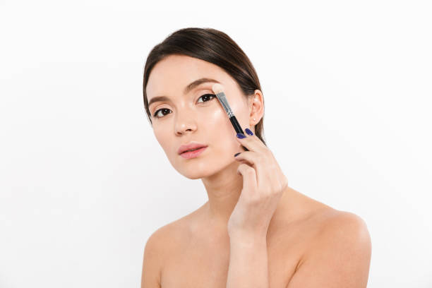 istock Young asian lady using brush for applying make up isolated 1270445569