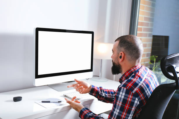istock Young man talking in front of computer with blank screen in video call 1270450075