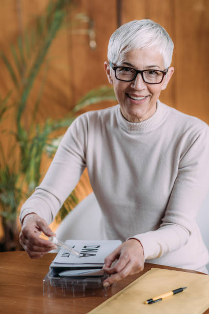 istock Senior Woman Doing A Mailed Dna Test At Home 1270451048