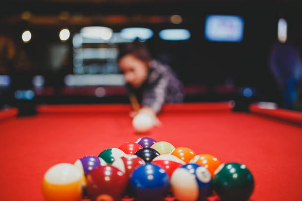 istock Young woman aiming at pool ball 1270451651