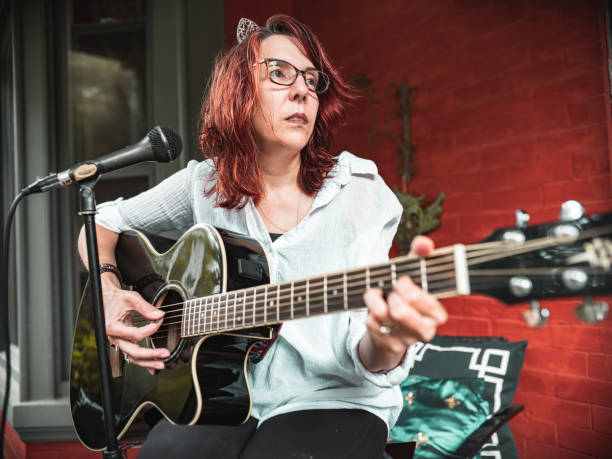 istock Woman playing acoustic guitar 1270453643