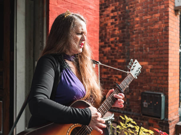 istock Woman playing acoustic guitar 1270454328