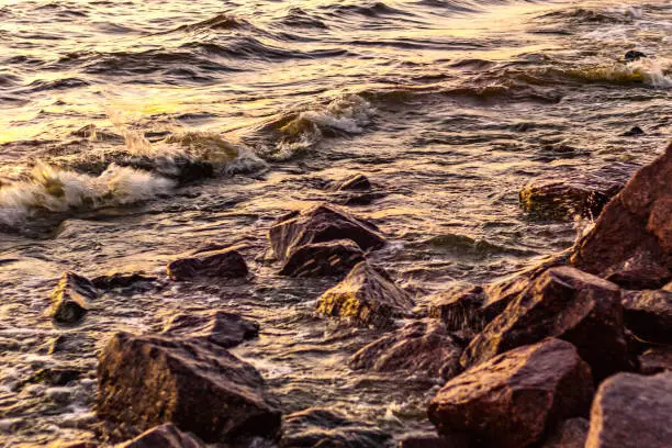 Photo of Rocky coast of the Gulf of Finland at sunset. Romantic evening. Summer