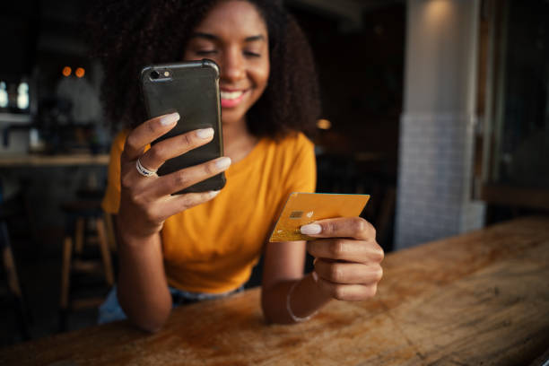 istock Young girl chatting while paying bill at coffee shop 1270455110