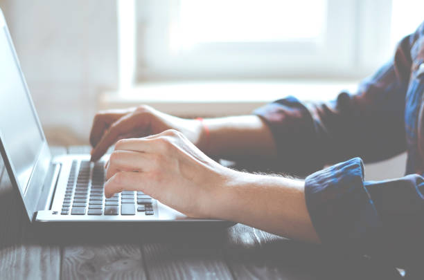 istock Working in the home office. Freelancer's hands on laptop keyboard 1270455318