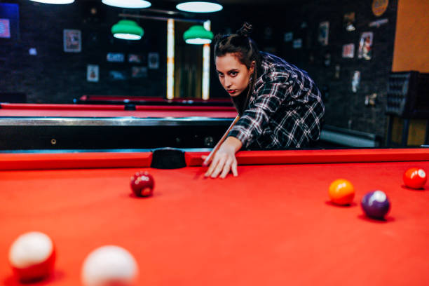 istock Woman aiming and playing pool in the bar 1270461242
