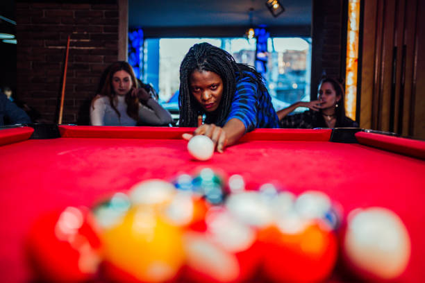 istock Young african american woman playing billiards 1270461625