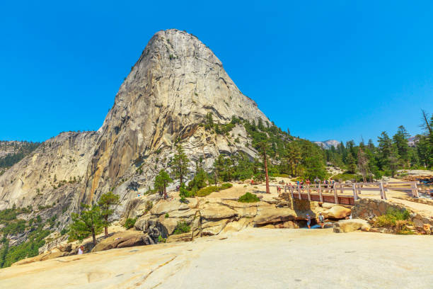 Yosemite Liberty Cap and Nevada Fall Liberty Cap peak and Bridge of Nevada Fall waterfall on Merced River from John Muir trail in Yosemite National Park. Summer travel holidays in California, United States of America. vernal utah stock pictures, royalty-free photos & images