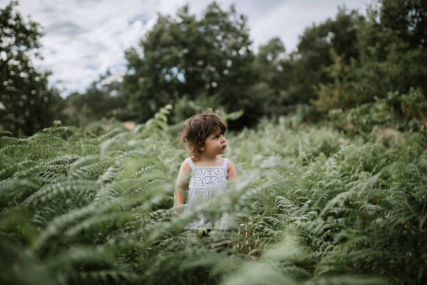 istock Cute Girl Looking Away Standing In Plants 1270463463