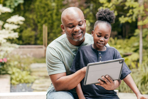 istock Dad helping his daughter with online school project 1270466750