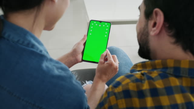 Couple Using Smartphone With Green Screen For Internet Website