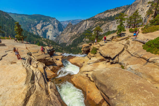 Yosemite Nevada Fall waterfall people Yosemite, California, United States - July 24, 2019: top view of Nevada Fall waterfall on Merced River from Mist Trail in Yosemite National Park. Summer travel holidays in California, United States. vernal utah stock pictures, royalty-free photos & images