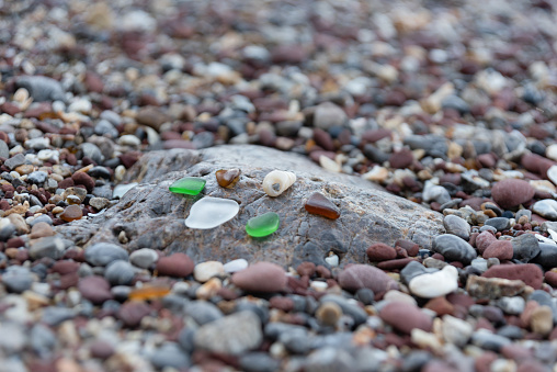 Sandy beach by the sea Arising from broken glass bottles Which was repeatedly hit by the waves until the sharp edges of the glass are gone