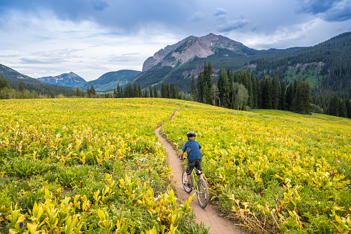 An 8 year old riding a bicycle in Crested Butte, Colorado.