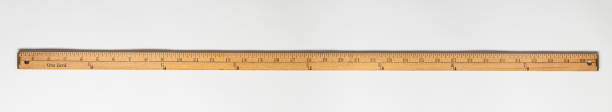 Wooden yardstick on white backgrounds whit inches and yard fractions scales. Horizontally positioned evenly lit measuring stick in high resolution. yard measurement stock pictures, royalty-free photos & images