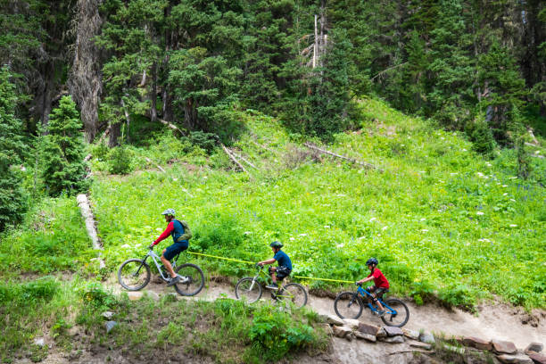 istock Dad Towing The Kids Mountain Biking 1270469598