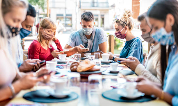 istock Young friends using tracking app with mobile smart phones - Bored people sharing content online on social media networks - New normal youth lifestyle concept - Bright filter with focus on central guy 1270469664
