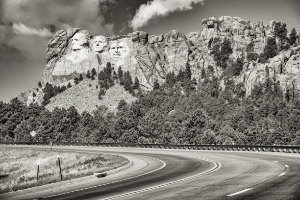 Road to Mount Rushmore The highway leading to the Mount Rushmore National Memorial which highlights the sculpture of four American presidents carved into the mountainside located in the Black Hills of Pennington County, South Dakota. theodore roosevelt us president stock pictures, royalty-free photos & images