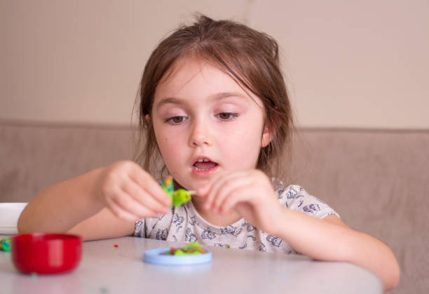 istock Little girl creating toys from playdough 1270471614