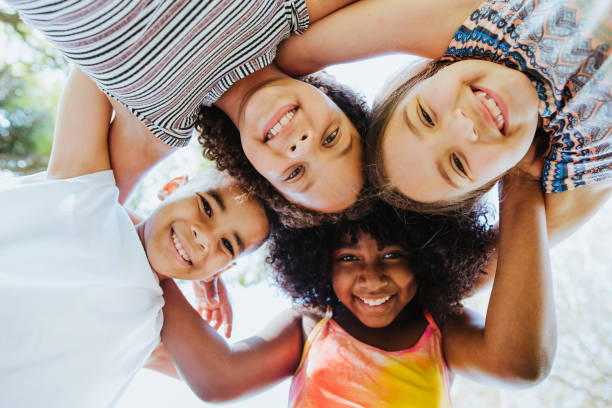 Group of children smiling and looking at the camera diversity Group of children smiling and looking at the camera below photos stock pictures, royalty-free photos & images