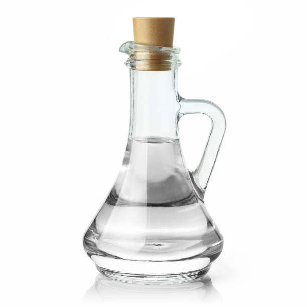 tarro de vidrio con agua o un poco de líquido transparente sobre blanco - distilled water fotografías e imágenes de stock