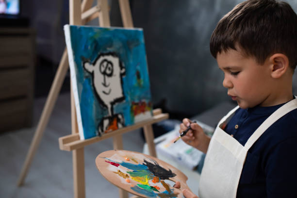 istock A boy choosing colors from a palette 1270476663