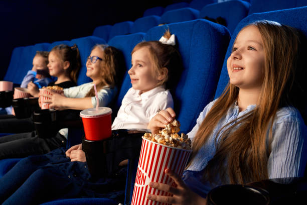 istock Happy friends eating popcorn in cinema. 1270477328