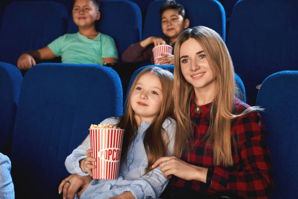 istock Mother hugging daughter in cinema. 1270479794
