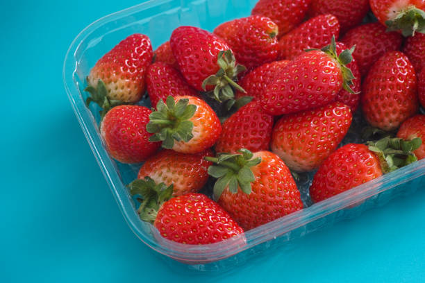 istock Freshly harvested strawberries in a plastic container 1270485865