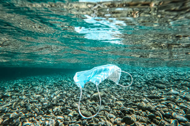 istock Thrown medical mask floats underwater 1270486712