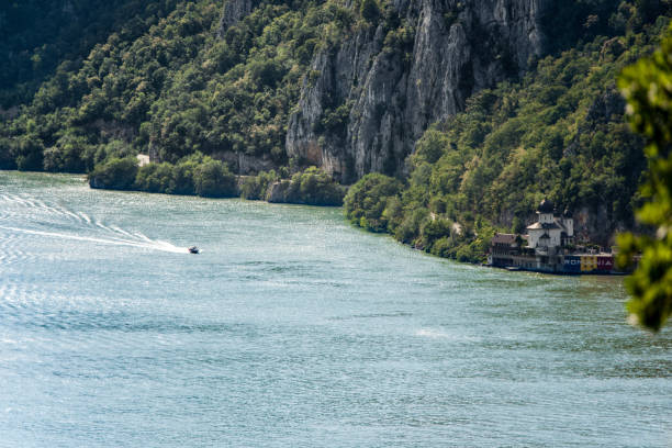 istock Boat riding through Danube river through the Djerdap gorge. Mraconia Monastery 1270488454