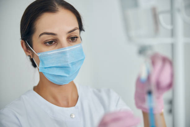 istock Focused female nurse getting ready for a medical procedure 1270488588
