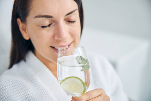 istock Smiling happy dark-haired woman enjoying her beverage 1270488635