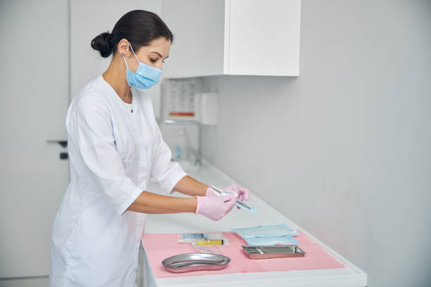 istock Female dermatologist unpacking a sealed biopsy tool 1270488780