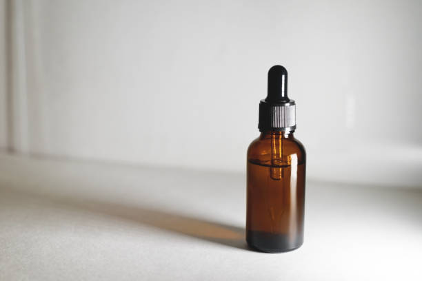 istock Serum glass bottle with pipette on grey background. 1270490042