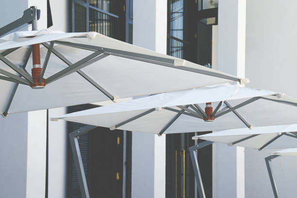 istock Closeup of Square White Patio Umbrellas 1270494151