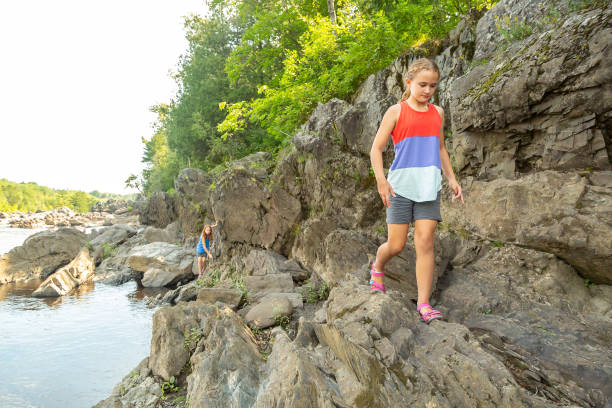 istock Girls Walking On Rocks Along River 1270494223