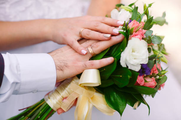 istock Bride and groom with a bouquet in hands, close-up. 1270495695