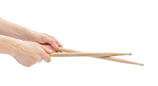 istock Woman's hands holding drum sticks. Isolated on white. 1270495984