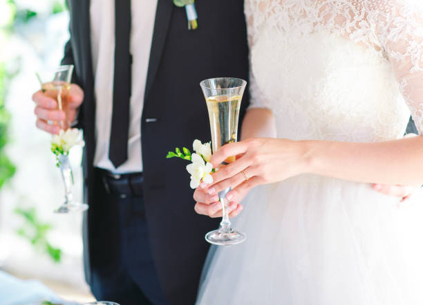 istock Bride and groom holding wedding champagne glasses 1270496946