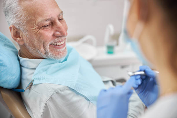 istock Joyful eldelry man sitting in a dental chair 1270497108