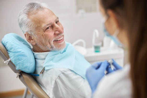 istock Edlerly man watching his dentist prepare a dental drill 1270497182