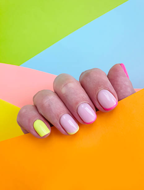 istock female hand beautiful manicure on a colored background 1270497354