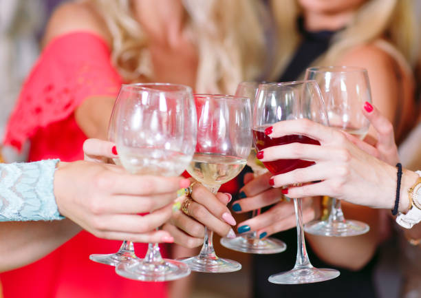 istock Hands holding glasses and toasting, happy festive moment. 1270498306