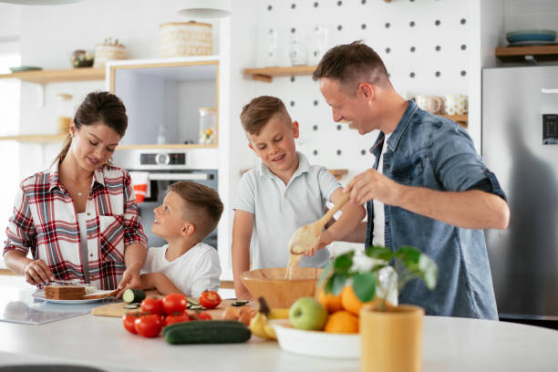 istock Mother and father making breakfast with sons 1270498832